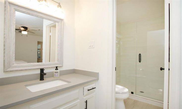 Primary Bath Vanity + ShowerUpdated ensuite bath with modern vanity and glass shower.