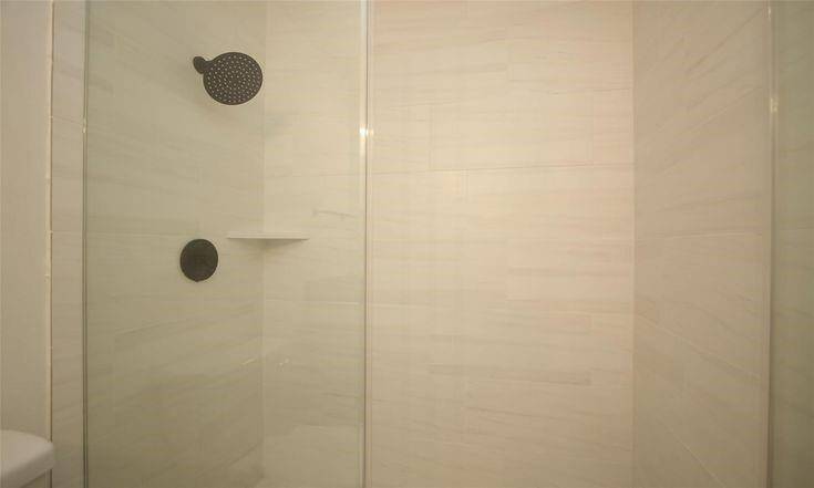 Shower Close-UpStylish walk-in shower with tile surround and matte black fixtures.