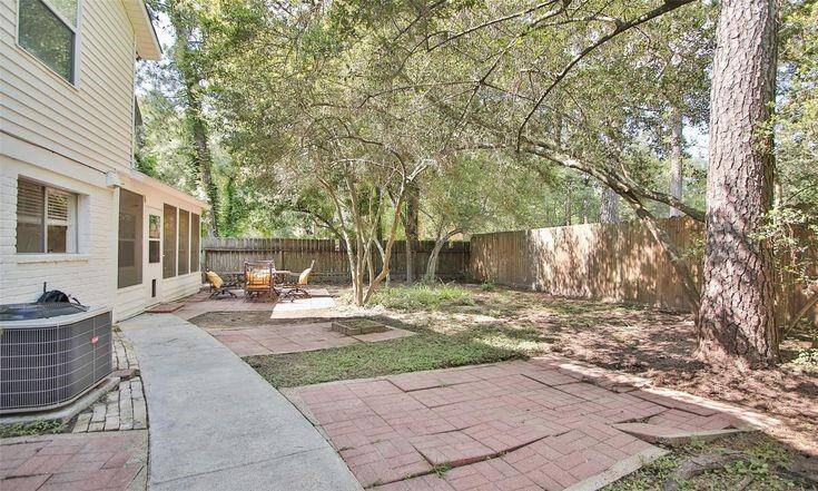 Backyard View 1Spacious yard with patio area and mature trees for privacy.