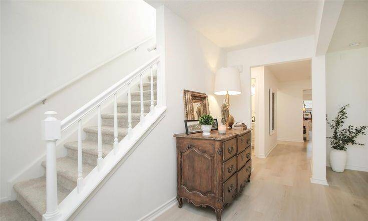 Hallway & StaircaseLight-filled hallway with neutral tones and updated flooring.