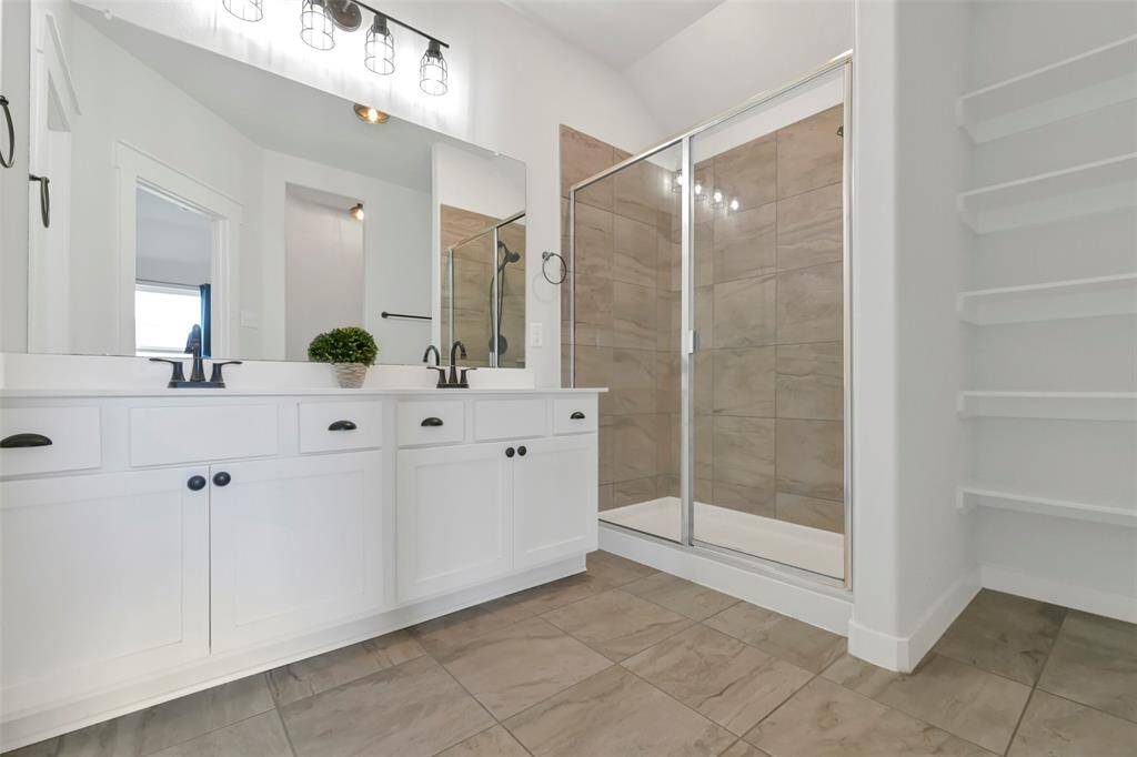 Master bath with double sinks and large showeer.