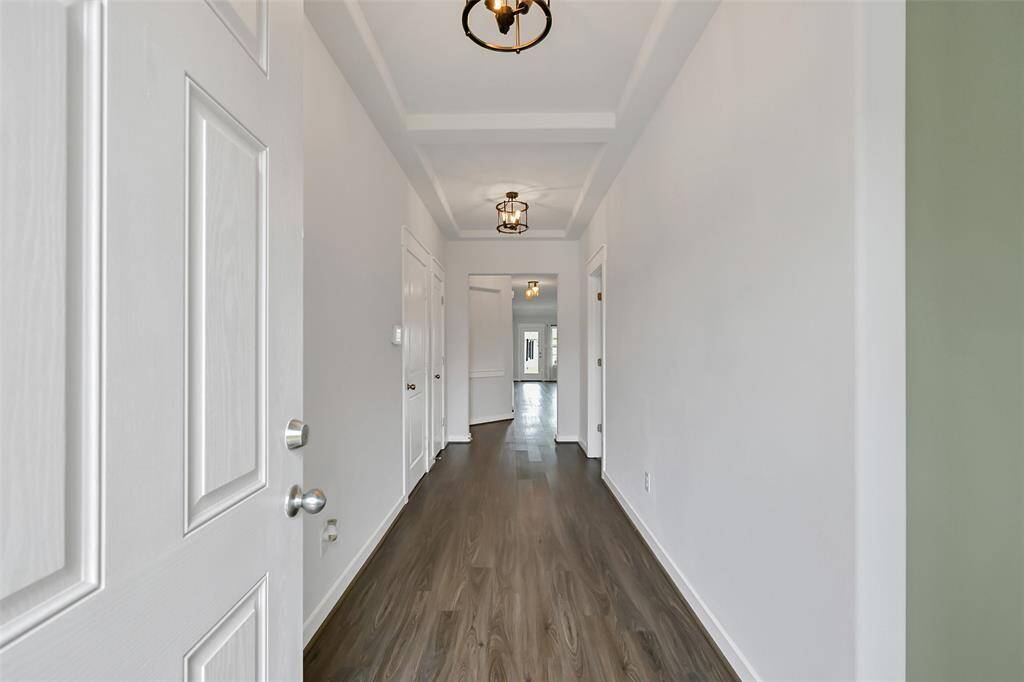 Entrance to home with coffered ceilings.