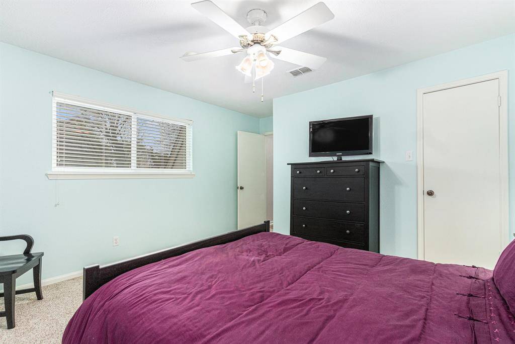 One of three secondary bedrooms on the second floor. Calming paint color, with neutral carpet and window blinds covering the double paned windows.