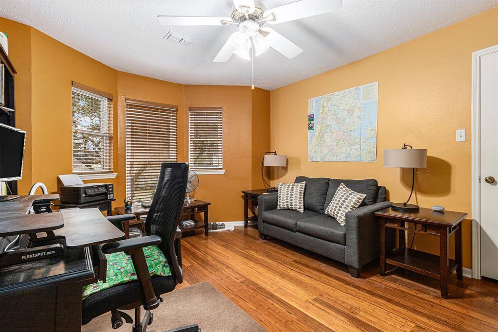 The middle bedroom with beautiful Bamboo floors is currently being used as an office. Bay window overlooking the lovely landscaped front yard allows for plenty of natural light.
