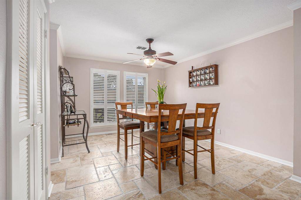 Generous size dining room accented with crown molding and Plantation shutters.