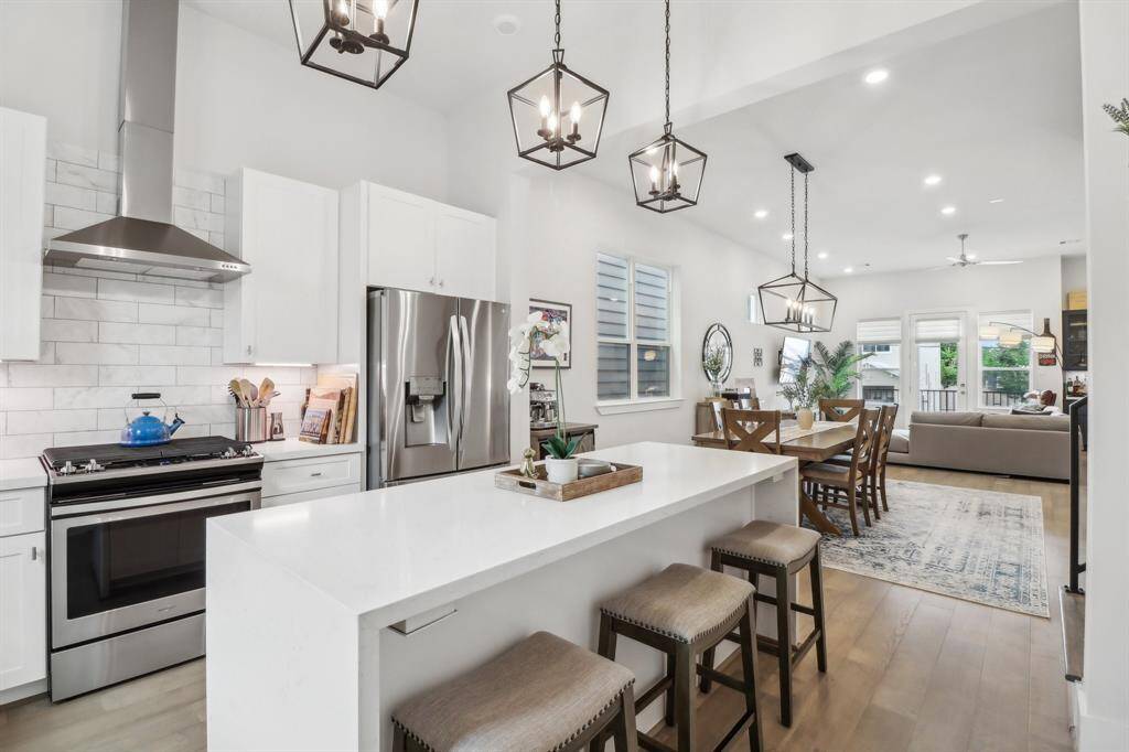 Kitchen island features waterfall and perfect spot for additional setting with barstools