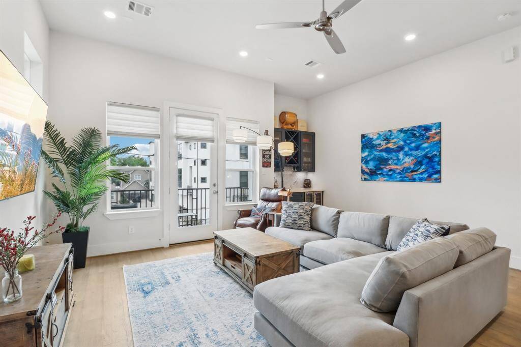 Large window and door open to 2nd floor balcony.