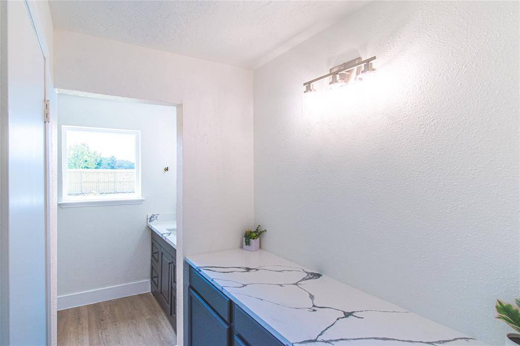 Elegant makeup area in the primary bathroom, featuring a sleek design and ample lighting.