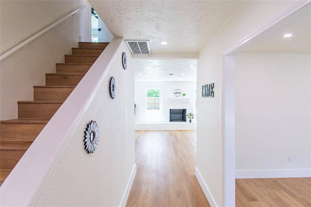 Welcoming entrance with convenient stairway access to the second floor.
