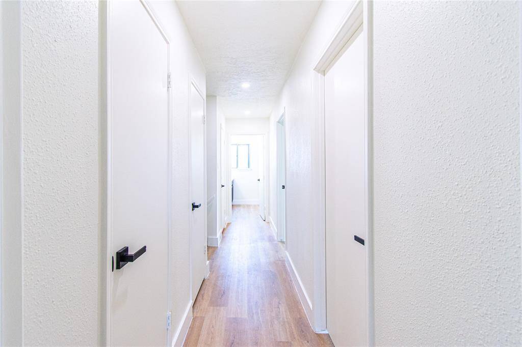 Bright and inviting second-floor hallway with modern finishes.
