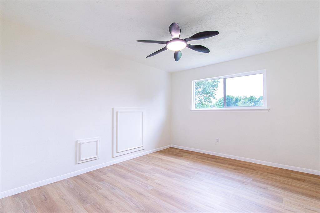 Bedroom 3 features sleek new flooring and updated windows for a fresh, modern feel.