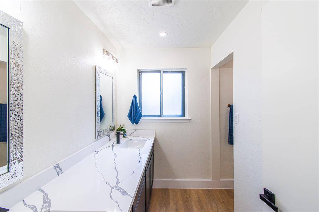 Luxurious second bathroom featuring sleek new quartz countertops.