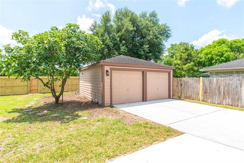Spacious detached garage with ample storage and privacy, perfect for vehicles or a workshop.