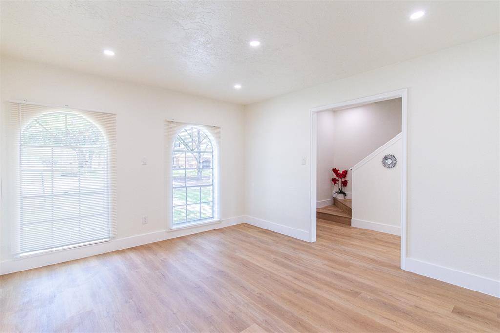 Elegant dining room with abundant natural light and stylish flooring, perfect for hosting memorable dinners.