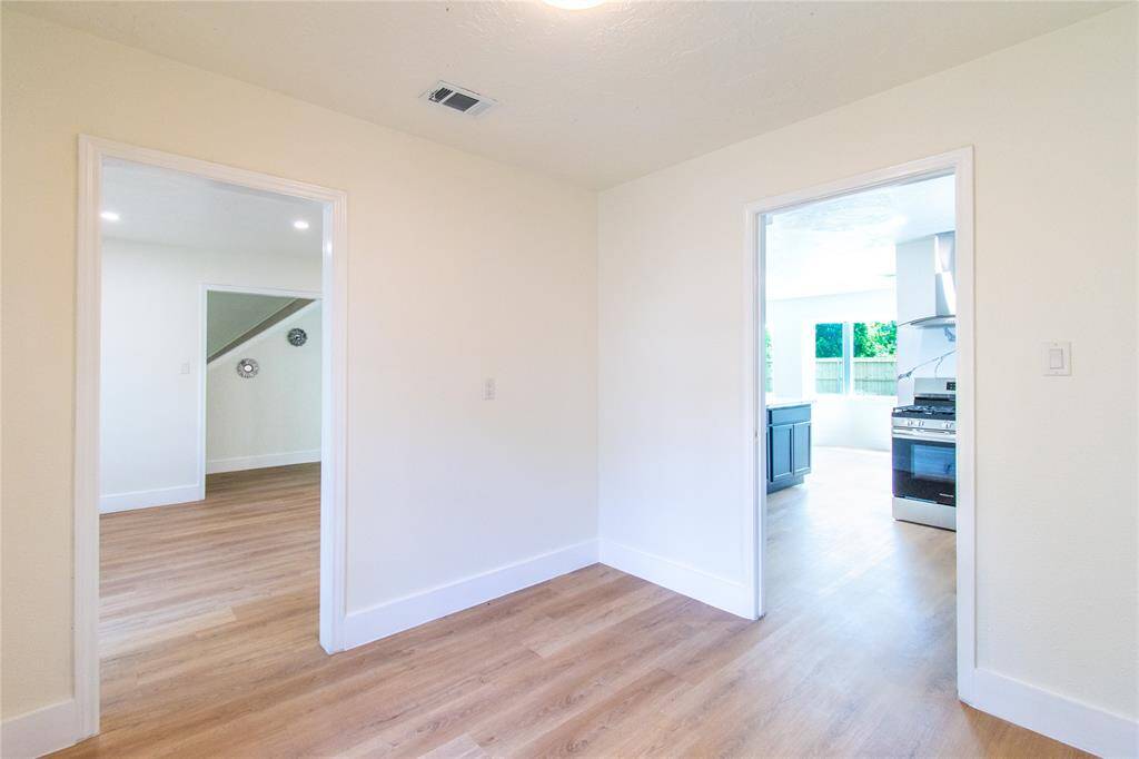 Versatile room adjacent to the kitchen, perfect for dining or a home office.