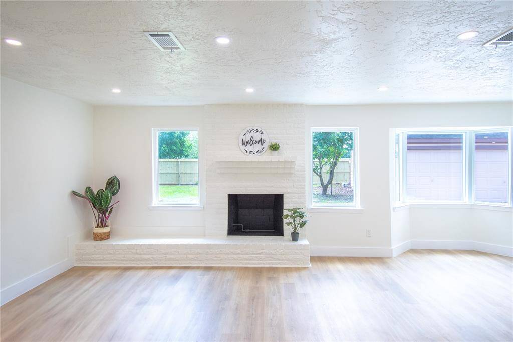 Cozy living space featuring a charming fireplace and brand-new, energy-efficient windows.
