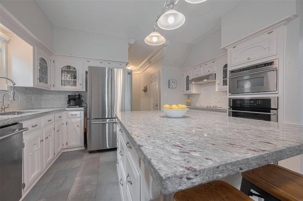 At the heart of the home, the stunning kitchen boasts numerous upgrades, including a spacious center island with sleek countertops and a convenient breakfast bar. Crisp white cabinetry adds a fresh, timeless touch, making this space perfect for both cooking and casual gatherings.