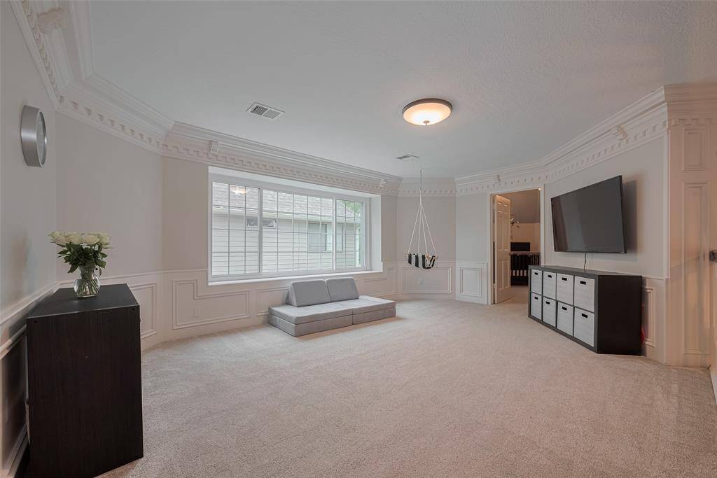 Ascend the staircase to the spacious second level, featuring a massive game room adorned with elegant double crown molding. Nearby, you’ll find the secondary bedrooms, thoughtfully designed for comfort and style.