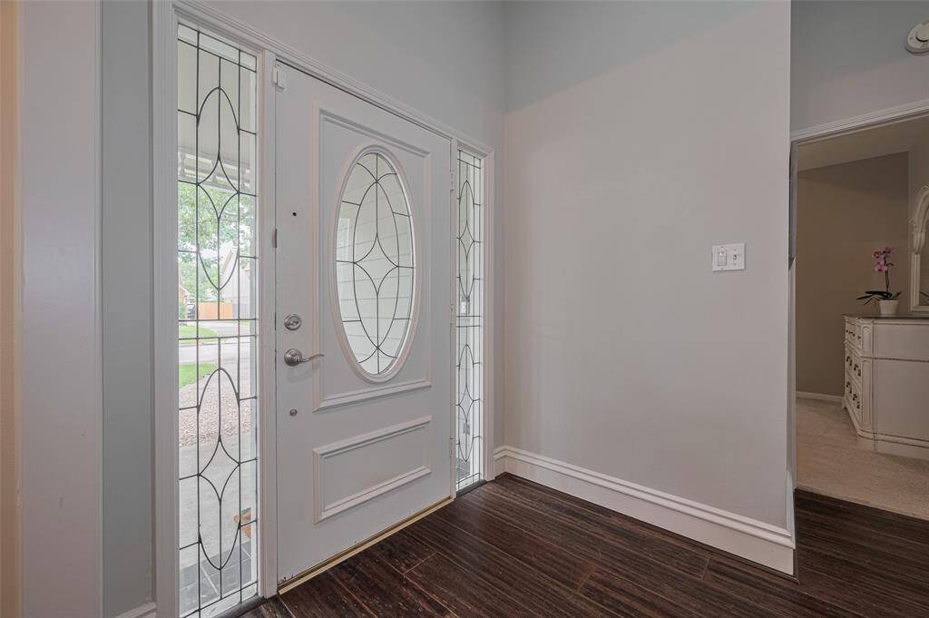 Step onto the welcoming front porch and through your front door framed by stunning cathedral glass sidelights—a beautiful detail that sets the tone for the charm and character found throughout the home. Underfoot, you'll find gorgeous bamboo flooring that extends throughout the main areas.
