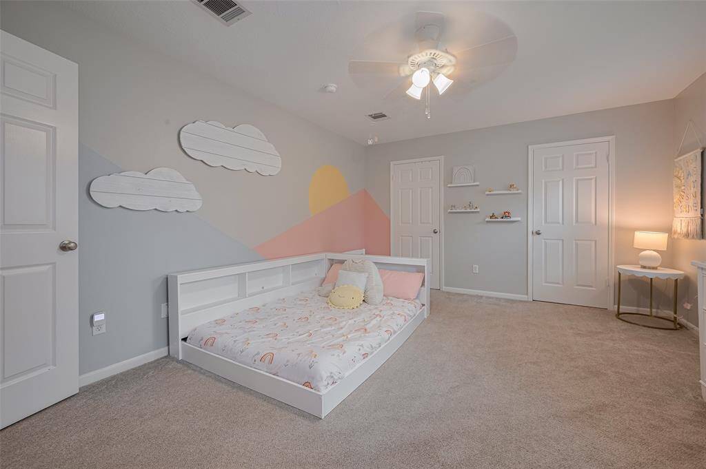 This spacious room easily accommodates a queen-size bedroom set and boasts two large closets, offering abundant storage and organization options.