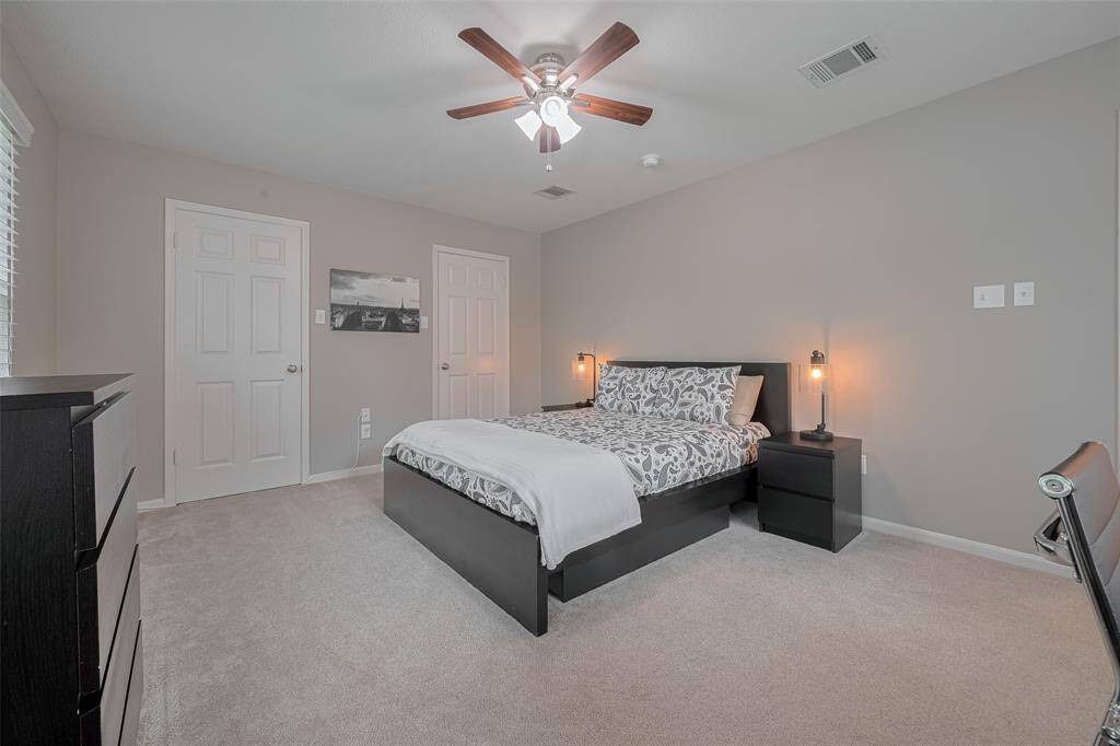 This spacious room easily accommodates a queen-size bedroom set and boasts two large closets, offering abundant storage and organization options.