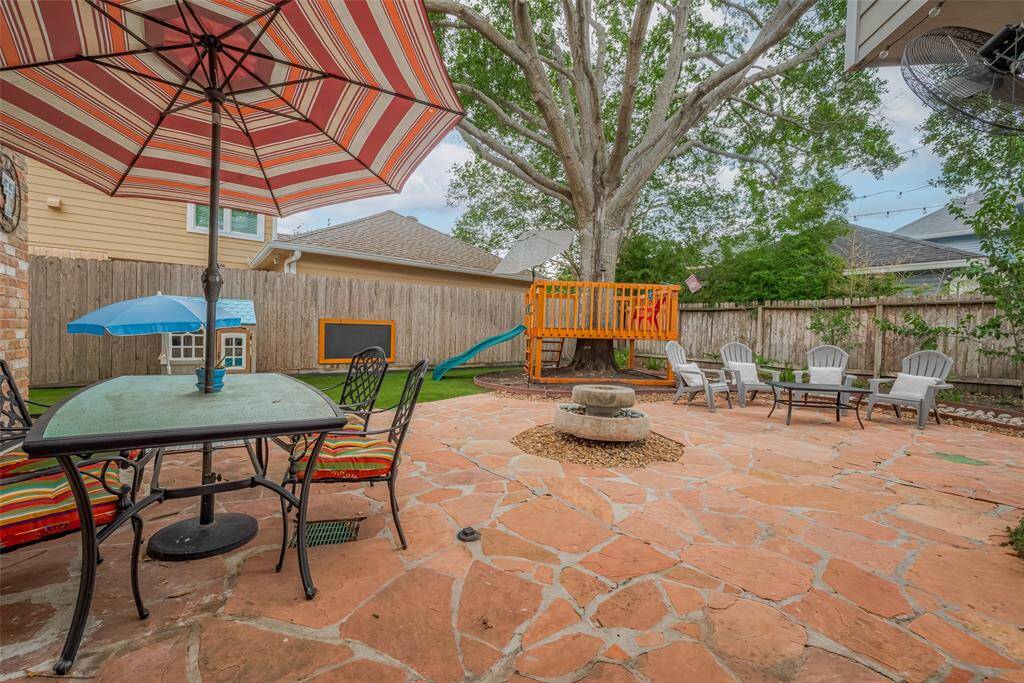 Step outside to a serene flagstone patio, complete with a soothing waterfall feature.