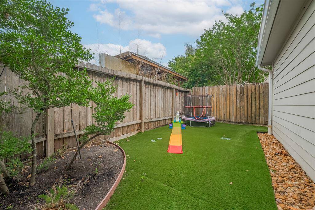 The low-maintenance turf extends around the back of the garage, complemented by a well-designed drainage system to ensure proper water flow and protect your outdoor space.