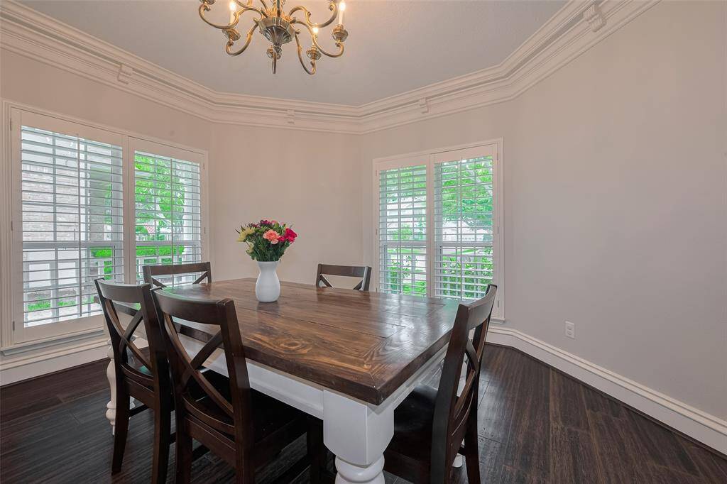 Far from cookie-cutter, this home exudes character at every turn. The dining space showcases a custom feel with thoughtful design details, anchored by a stunning chandelier that adds a touch of elegance and warmth.