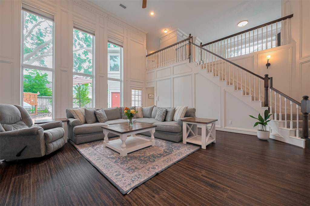 Meticulous craftsmanship is evident throughout, with exquisite woodwork that brings warmth and sophistication to the space. Massive picture windows frame serene views of the backyard and towering trees, blending indoor comfort with natural beauty.