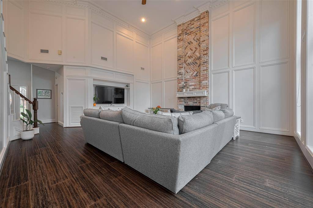 Cozy up by the fireplace on a cool day and enjoy your favorite shows from the comfort of your sofa looking toward the built-in entertainment center.