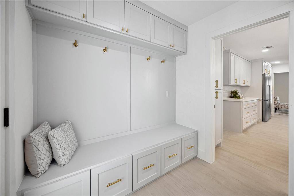 The mudroom includes built-in cabinetry, perfect for keeping your home organized and clutter-free.