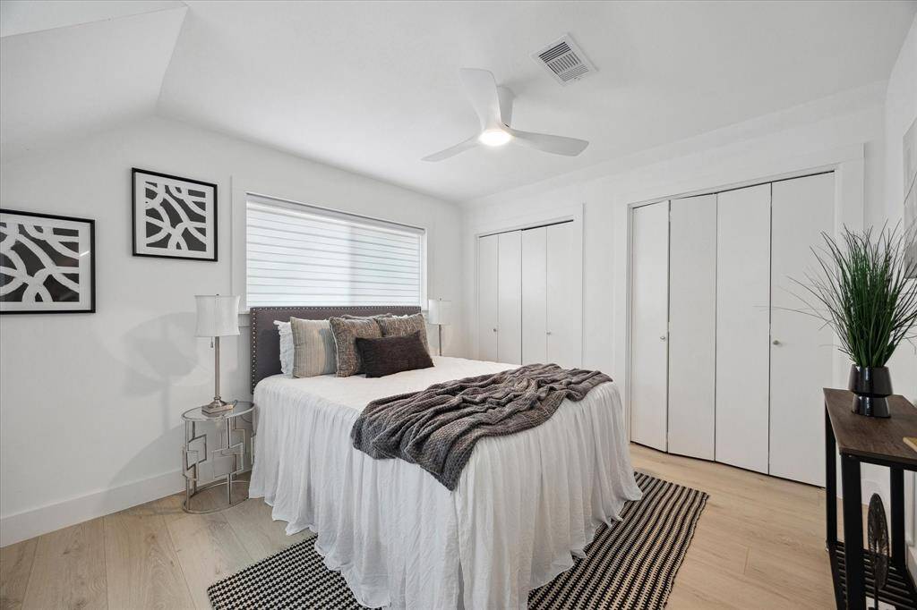 This stunning secondary bedroom includes great closet storage and timeless design touches.