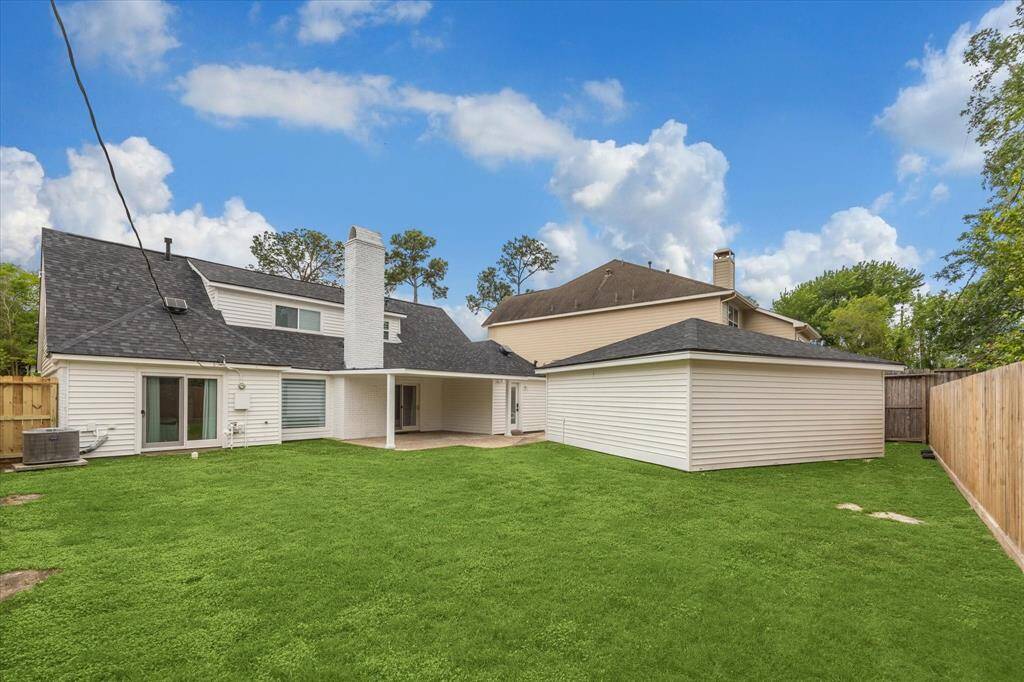 Step into a spacious backyard with plenty of green space for outdoor fun and play.
