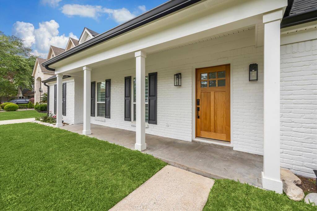 A beautiful covered front porch warmly welcomes you—perfect for enjoying morning coffee or evening chats.