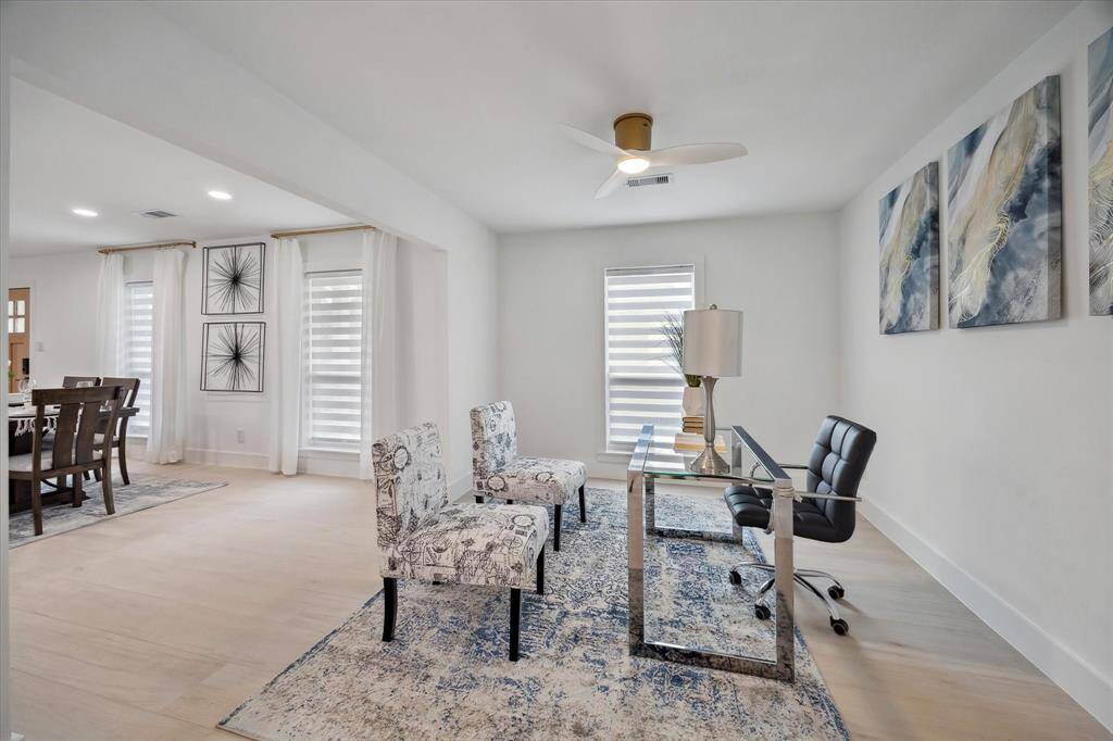 Just off the entryway, a stylish office or flexible space offers privacy and functionality for work or relaxation.