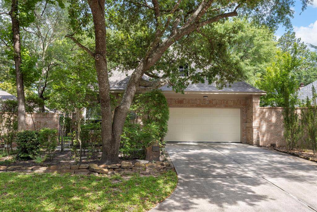 This charming brick patio home offers a peaceful, shaded setting with mature trees and a private, gated entryway.