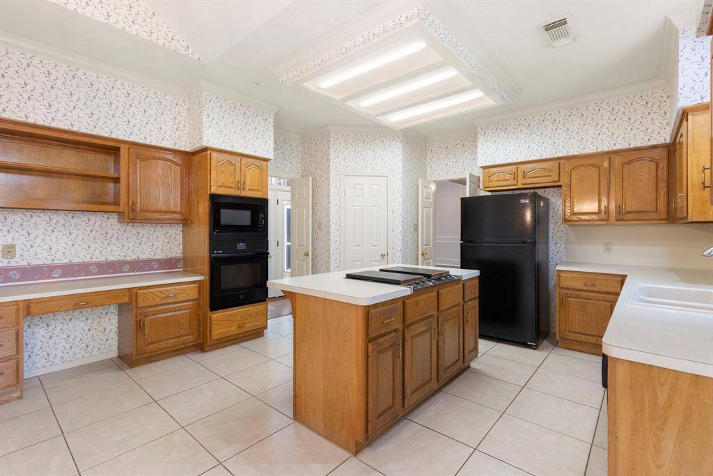 Equipped with a built-in microwave and oven, plus a thoughtfully placed desk nook for added functionality.