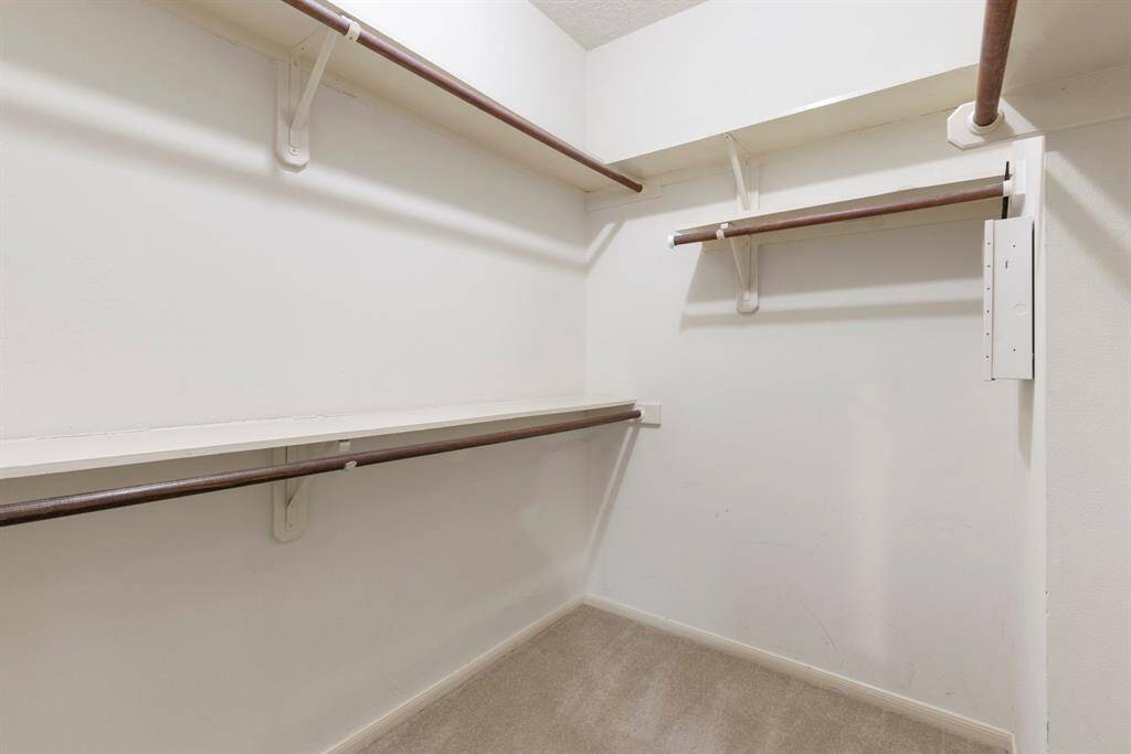 The primary suite features two walk-in closets, offering ample space and built-in storage for optimal organization.