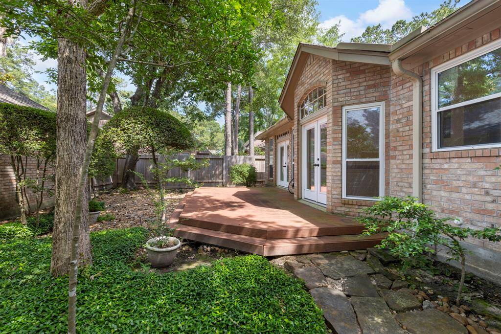 This private side yard retreat features a raised deck with direct access from the primary suite and breakfast nook.