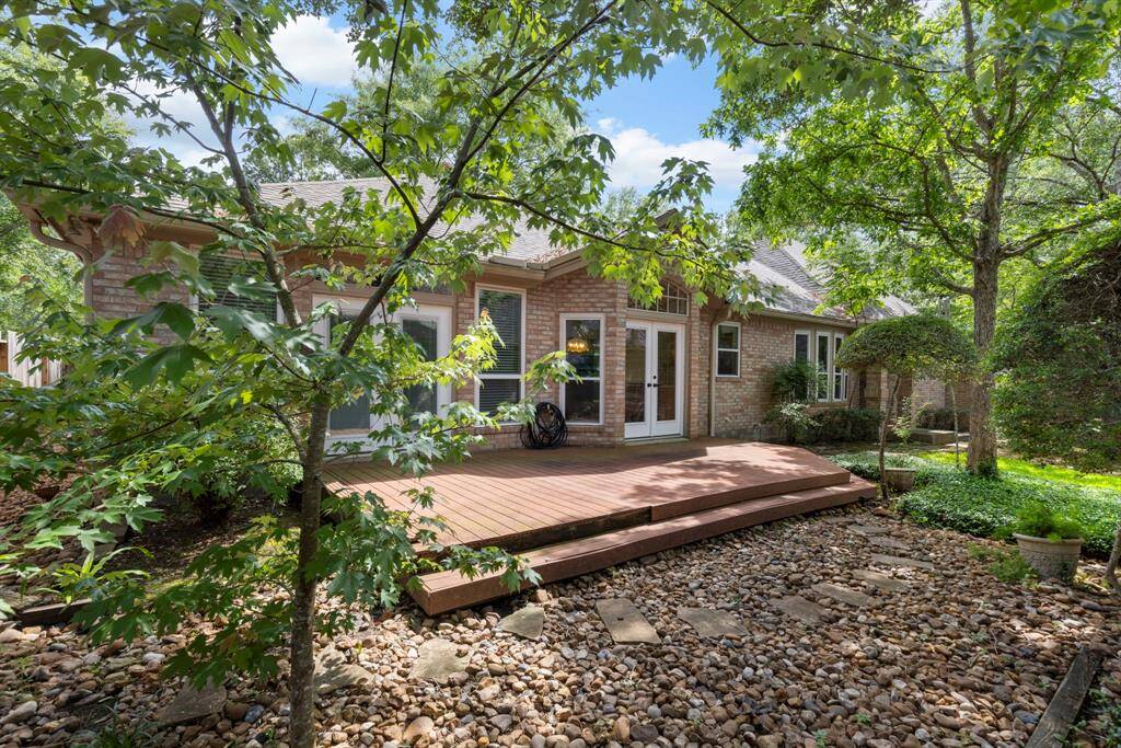 Surrounded by mature trees and lush greenery, this peaceful deck invites you to enjoy serene afternoons or intimate gatherings in a private, low-maintenance backyard escape.