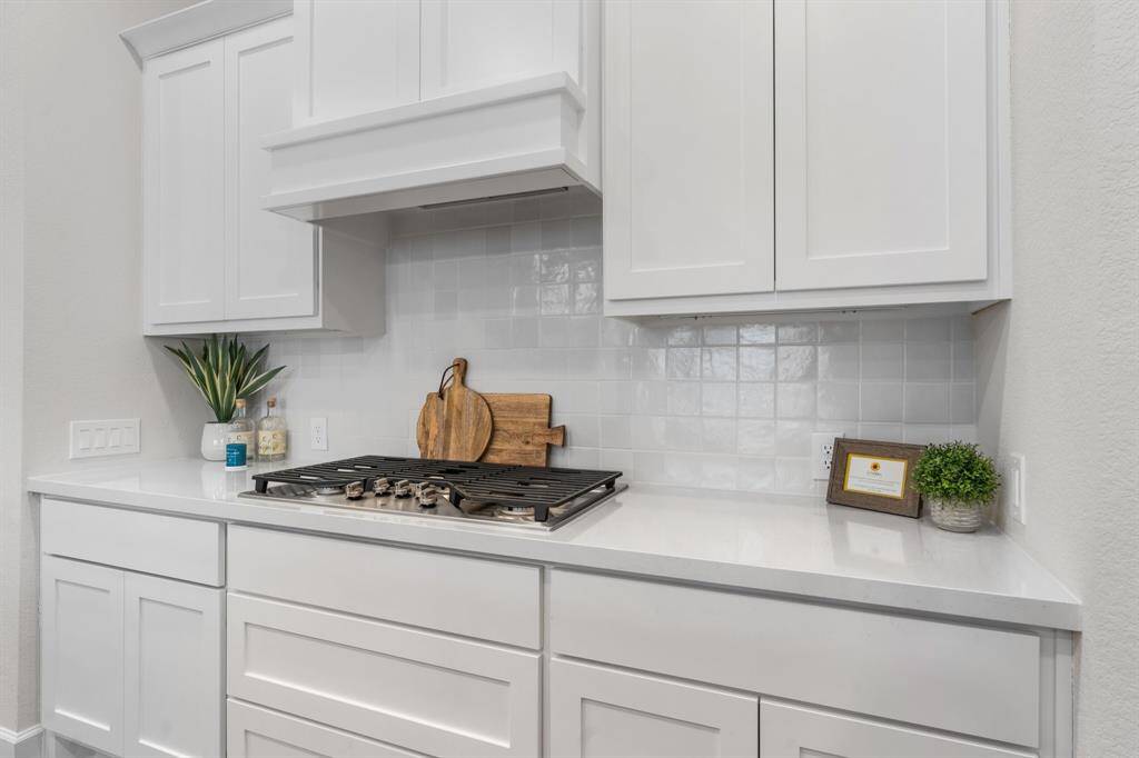 Kitchen showing off natural light, recessed and pendant lights. Inviting open concept for all of your gatherings. Refrigerator included!