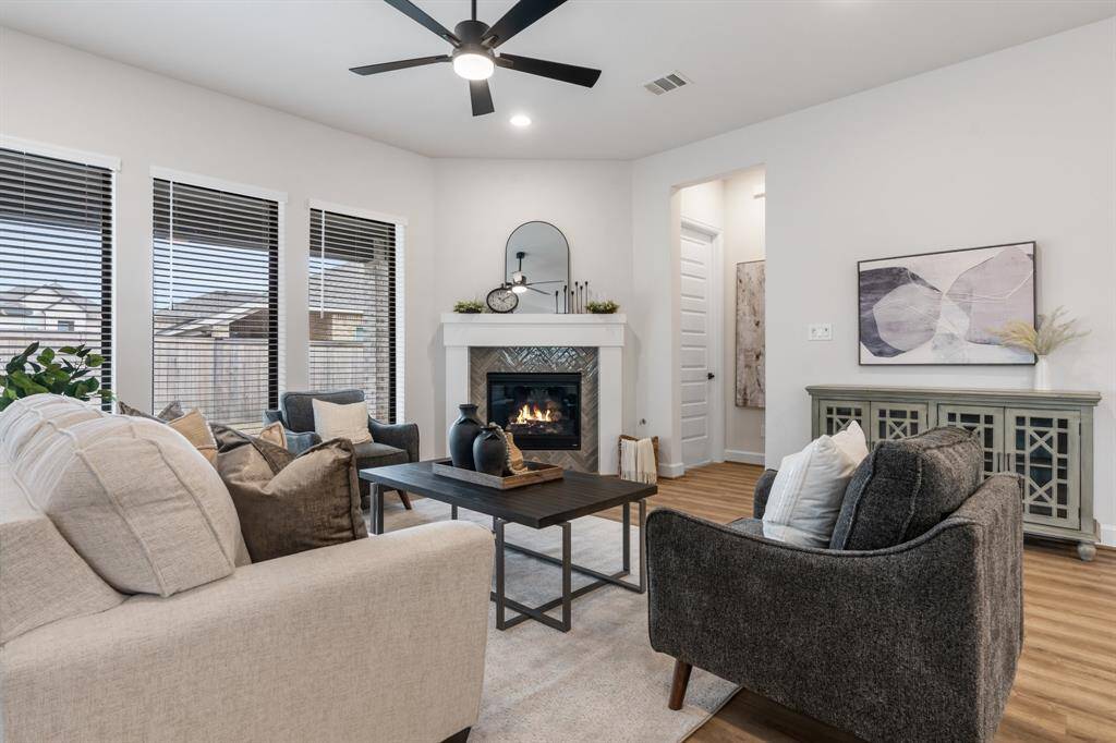 Family room with space for sectional or all of your favorite pieces. Wall of windows provides natural light. Door leads to oversize back patio.