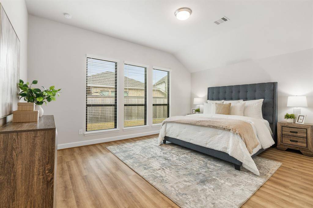 Large primary suite with tall windows and room for all your furniture. Notice no carpet in this home.