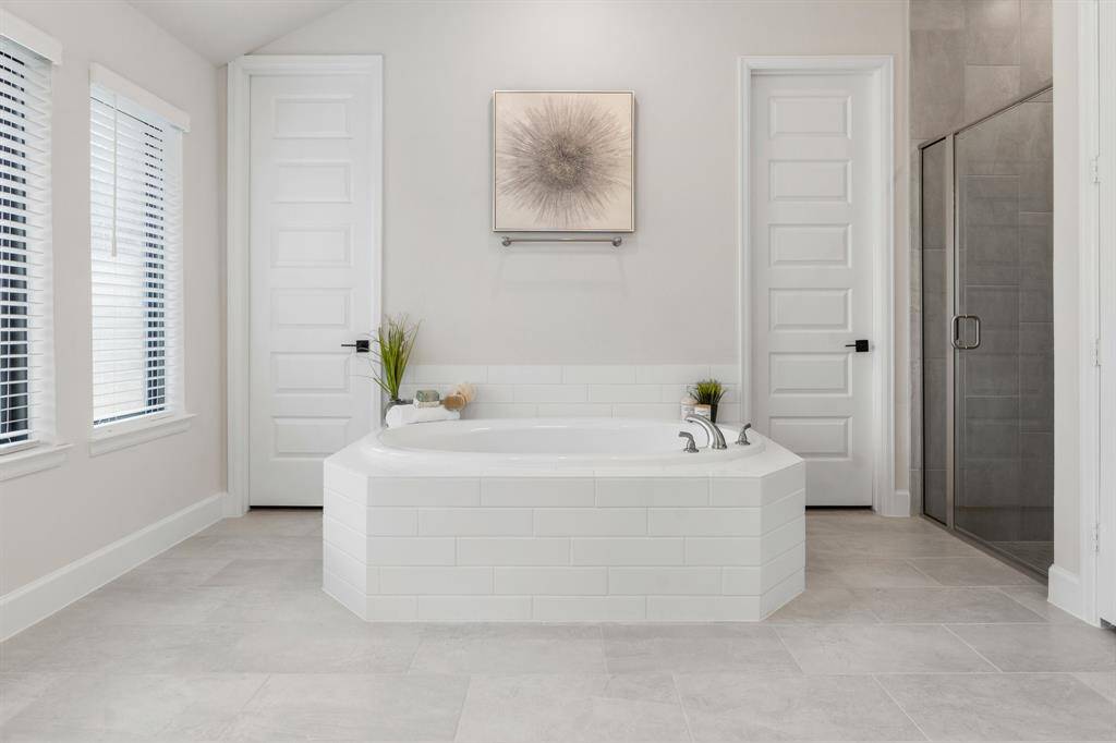 Read a book, have a glass of wine, enjoy this gorgeous soaking tub! Oversized shower with tile to the ceiling. TWO large walk in closets!