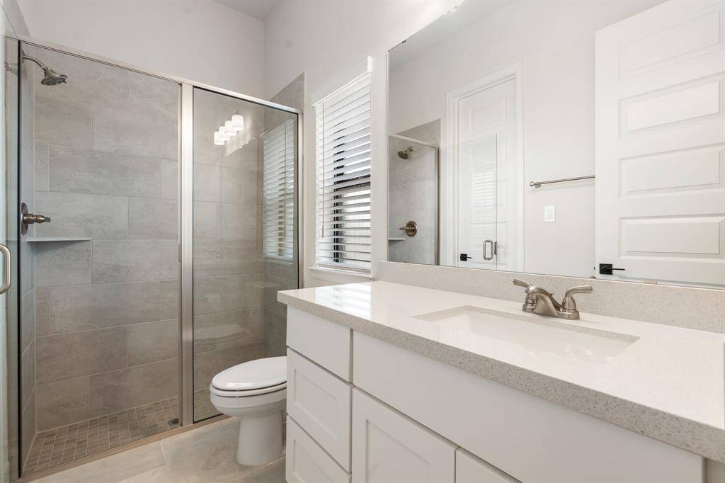 Secondary en suite bath with walk in shower.