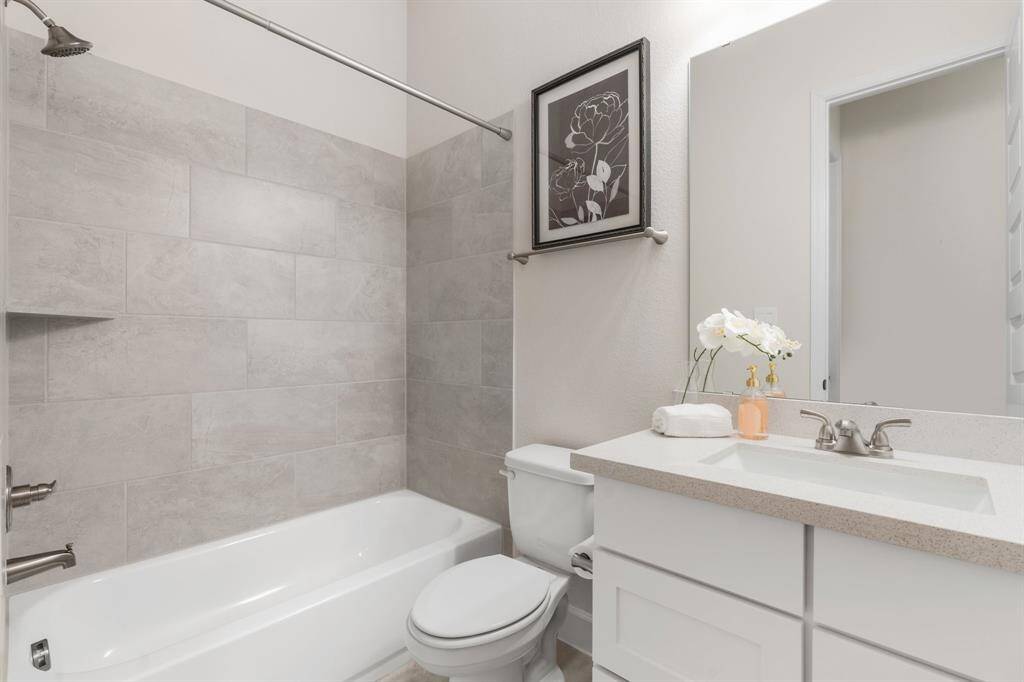 Secondary shared bath with tub/shower combo.