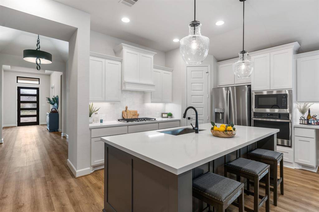 Dining area is a great size with natural light and long serving counter. There is a cutout with plug for your wine or beverage refrigerator. Perfect for entertaining!