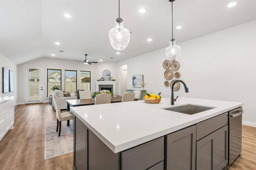 Kitchen is light and bright with under cabinet lighting. Notice custom light in entry hall!
