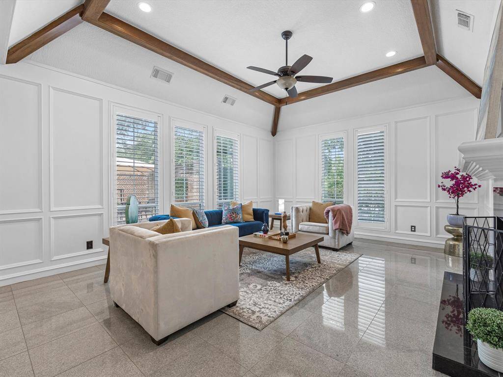 This Living Room features plenty of natural light and plantation shutters, in a elevated setting.
