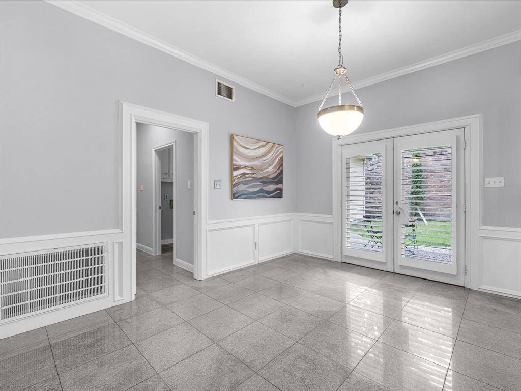 The Breakfast Room with French Doors and Plantation Shutters leading to the backyard.